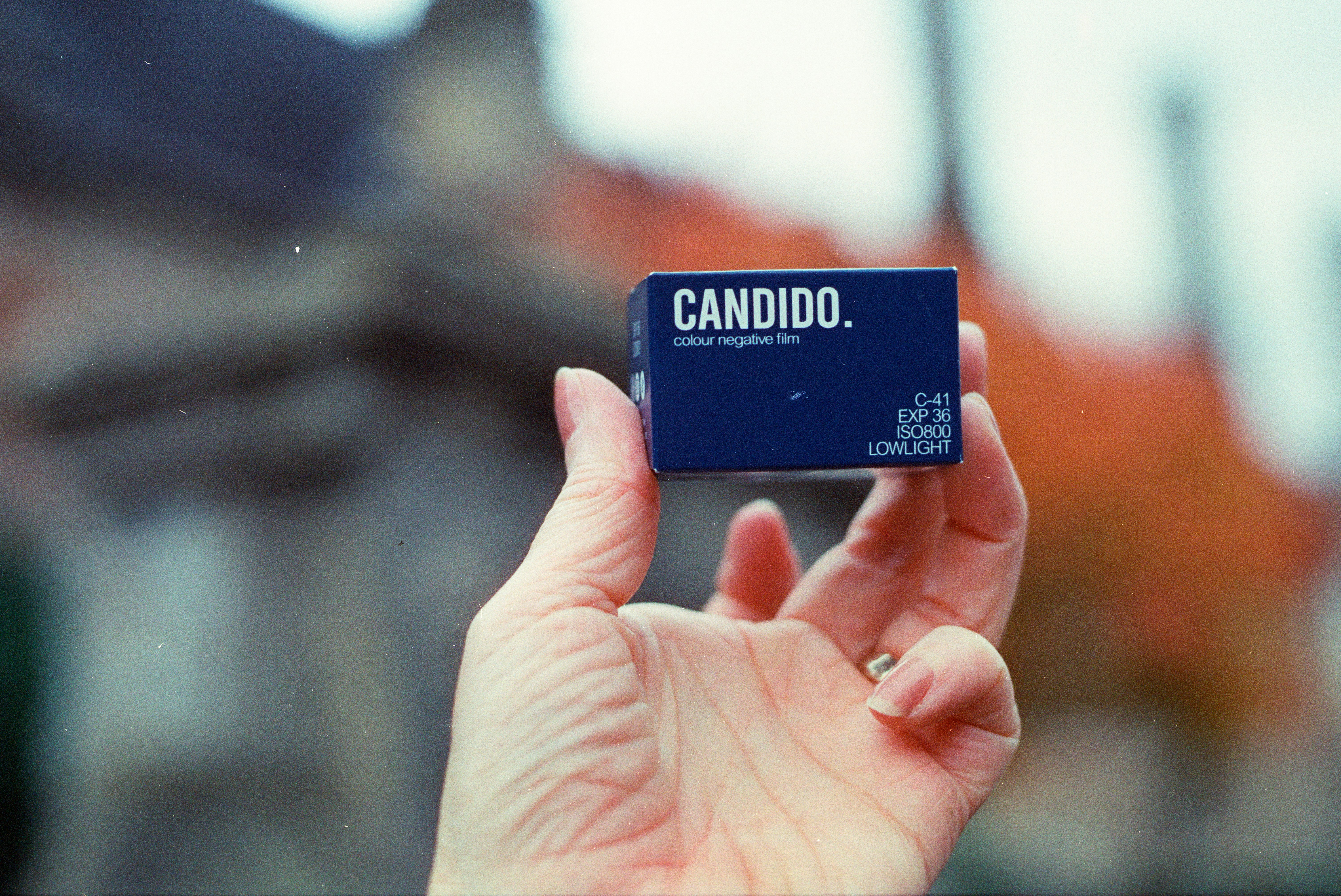 Hand holds small blue box with text